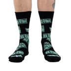 Flatlay image showcasing the black crew socks with green $100 bill design, highlighting the overall pattern.