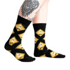 Lifestyle shot of 'Pirate Crossing' socks on a model's legs, showcasing the fit and design on the feet.
