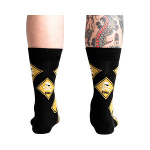 Rear view of 'Pirate Crossing' socks worn on a model's legs showing how the socks fit.