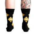 Rear view of 'Pirate Crossing' socks worn on a model's legs showing how the socks fit.