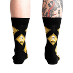 Rear view of 'Pirate Crossing' socks worn on a model's legs showing how the socks fit.