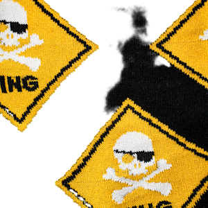 Close-up detail of the 'Pirate Crossing' sock's fabric, highlighting the skull and crossbones design and the knit texture.