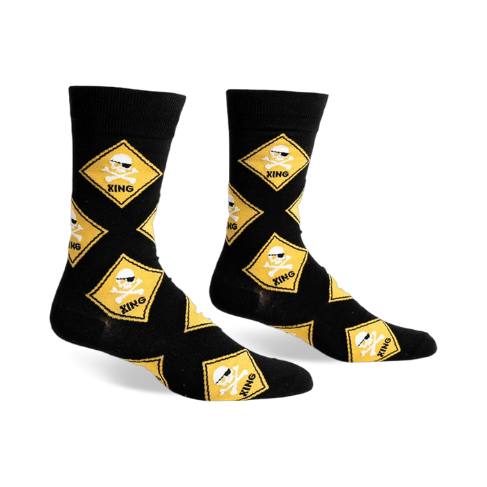 Black crew socks with a repeating pattern of yellow diamond-shaped warning signs featuring skulls wearing sunglasses and crossbones.