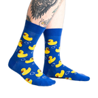Lifestyle shot of a person's legs wearing the Rubber Duckie socks, showcasing the fit and design on a person.