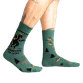 Lifestyle shot showing Krampus Believes in You socks on a person's legs.