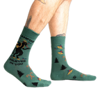 Lifestyle shot showing Krampus Believes in You socks on a person's legs.