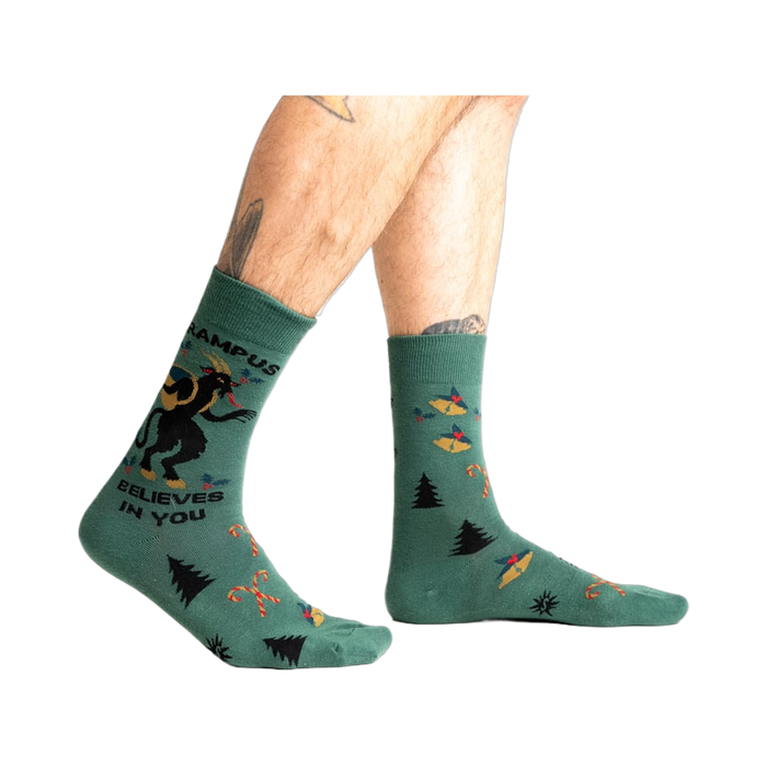 Lifestyle shot showing Krampus Believes in You socks on a person's legs.