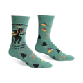 Green crew socks with a Krampus design, candy canes, and Christmas trees.  Features black and red accents.