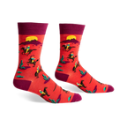 Crew socks in red and burgundy featuring a repeating pattern of cowboys riding horses against a desert sunset background.