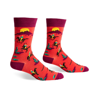 Crew socks in red and burgundy featuring a repeating pattern of cowboys riding horses against a desert sunset background.