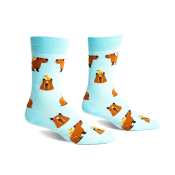 Pair of crew socks; light blue background with repeating pattern of brown capybaras and small yellow ducklings.