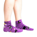 Lifestyle shot: Model wearing the purple 'Witch, Please' socks, showcasing the fit and style.