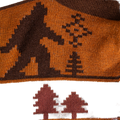 Close-up detail shot showcasing the Bigfoot and tree design on the socks.
