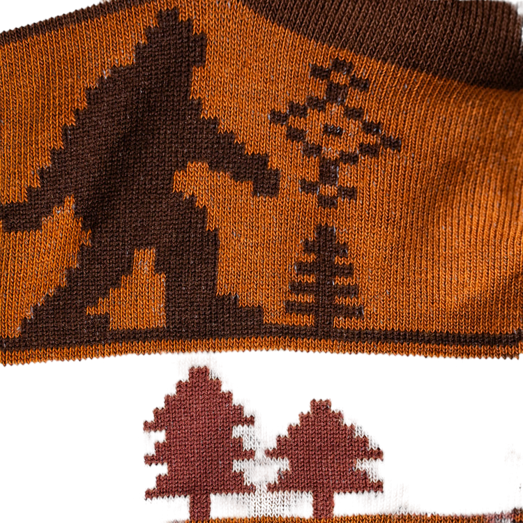 Close-up detail shot showcasing the Bigfoot and tree design on the socks.