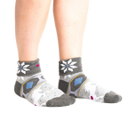 Lifestyle shot: Model wearing the grey and white 'I Believe in Sweater Weather' turn-cuff socks.