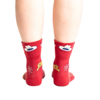 Rear view of the socks on a person's feet, highlighting the design on the back of the socks.