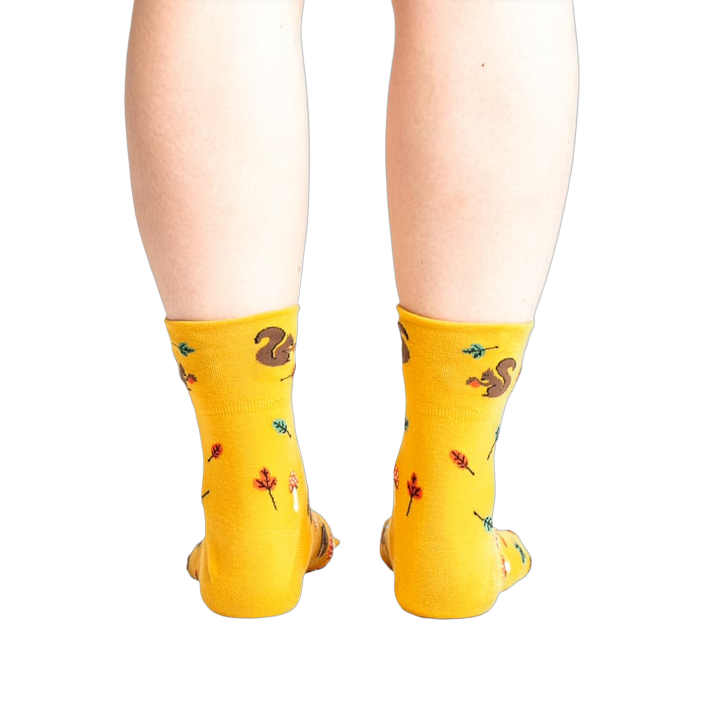 Rear view of a person wearing mustard yellow socks with a squirrel design.