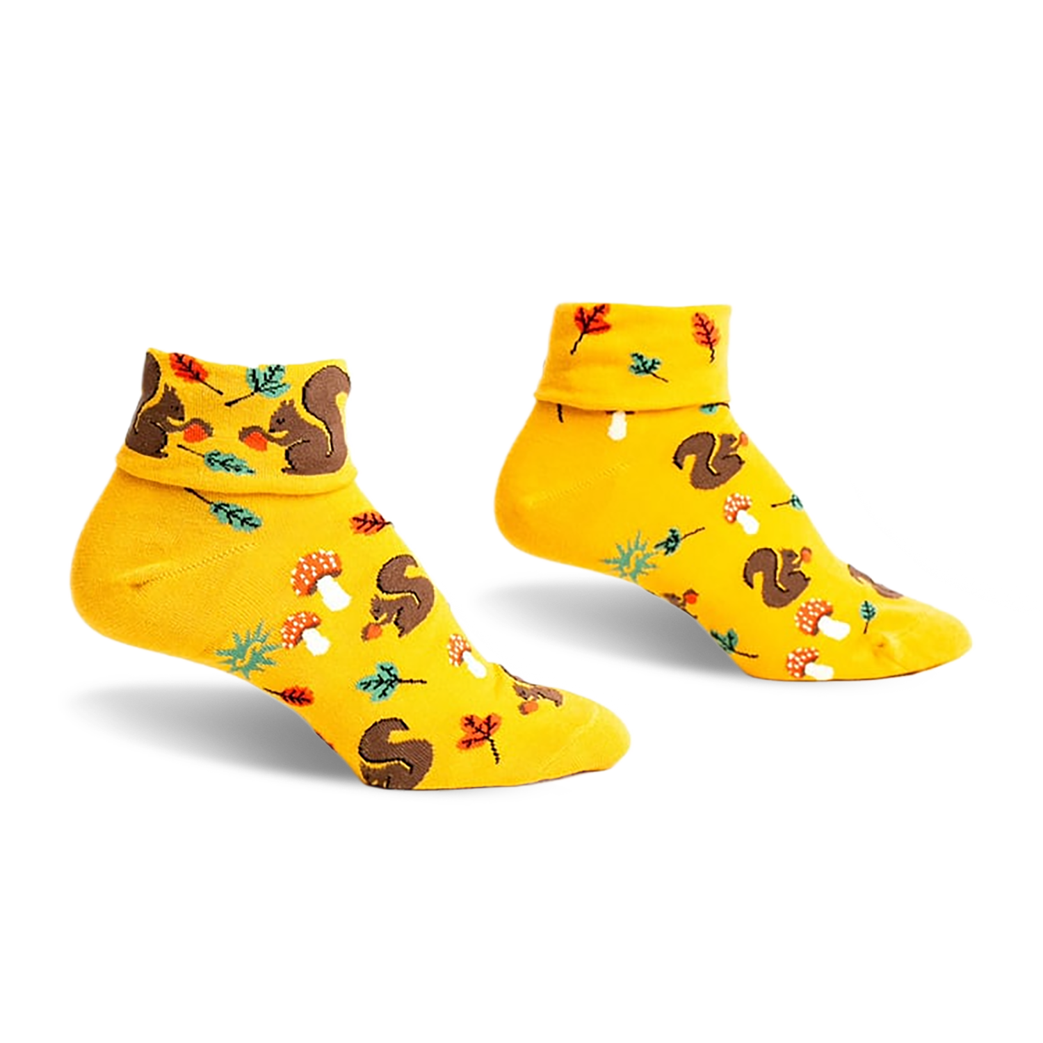 Pair of mustard yellow ankle socks featuring a playful pattern of squirrels, mushrooms, and leaves. Turn-cuff design.