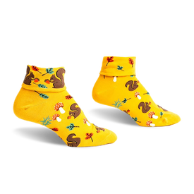 front view of a pair of yellow socks with a squirrel and mushroom pattern.