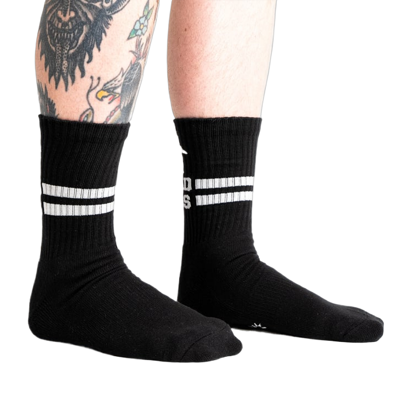 Lifestyle shot showing black Bad Ass Athletic Ribbed socks on a person's legs.