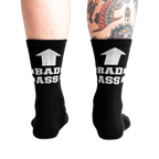 Pair of black ribbed athletic socks with white "BAD ASS" text and upward arrow graphic.