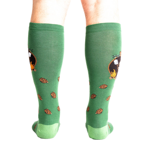 Rear view of a person wearing the 'S'more Where That Came From' knee-high socks, showing the full design on both socks.