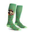 A pair of green knee-high socks with a whimsical design. One sock shows a squirrel roasting a marshmallow by a campfire; the other has scattered pine cones.