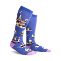Pair of blue knee-high socks with a whimsical design featuring stacks of books, candles, and mushrooms. Purple accents at the cuff.