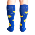 Rear view of a model's legs wearing the blue rubber duckie knee-high socks.