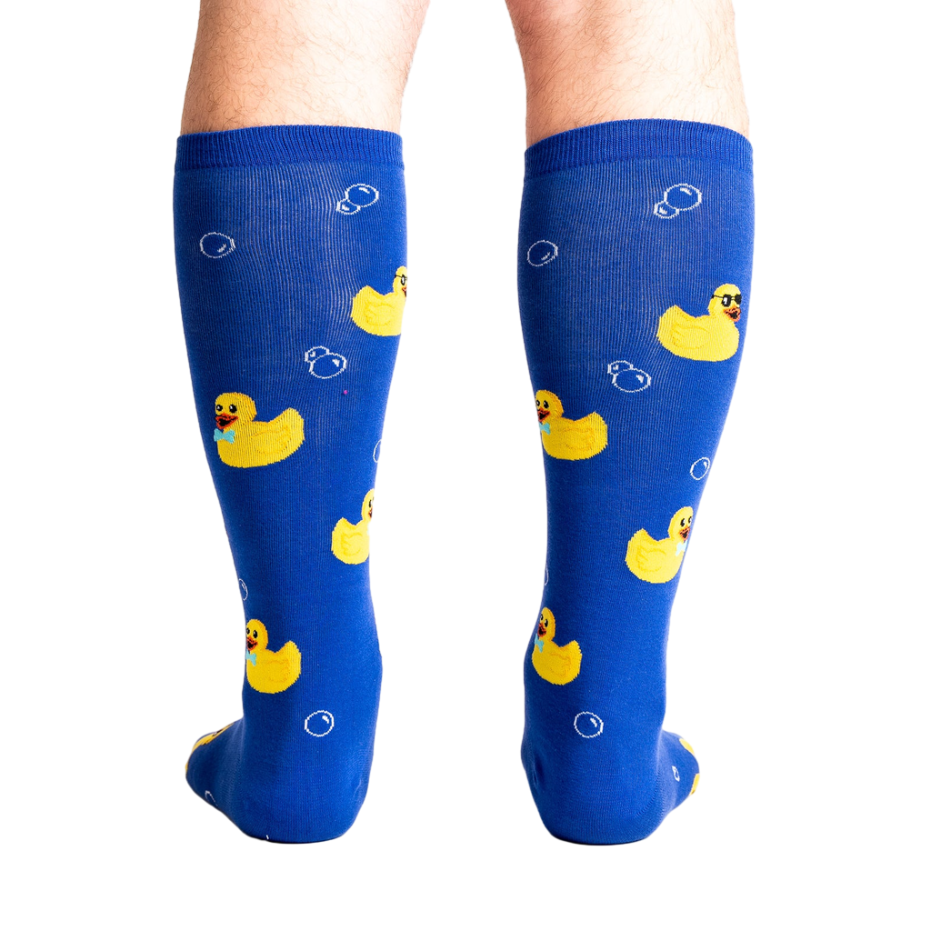 Rear view of a model's legs wearing the blue rubber duckie knee-high socks.