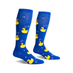 Pair of blue knee-high socks with yellow rubber duckies wearing sunglasses and bow ties, and white bubbles printed on them.