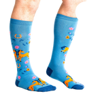 Lifestyle shot showing 'Hay There' socks on a person's legs, highlighting the extra stretch.