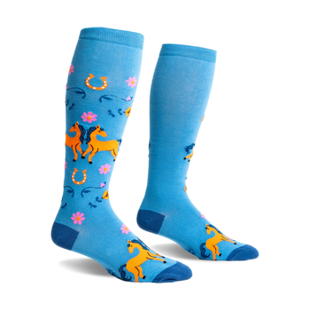 Pair of bright blue knee-high socks with an all-over pattern of orange horses, pink flowers, and golden horseshoes.