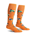 Pair of mustard yellow knee-high socks with a repeating pattern of horses wearing blue and black plaid blankets.
