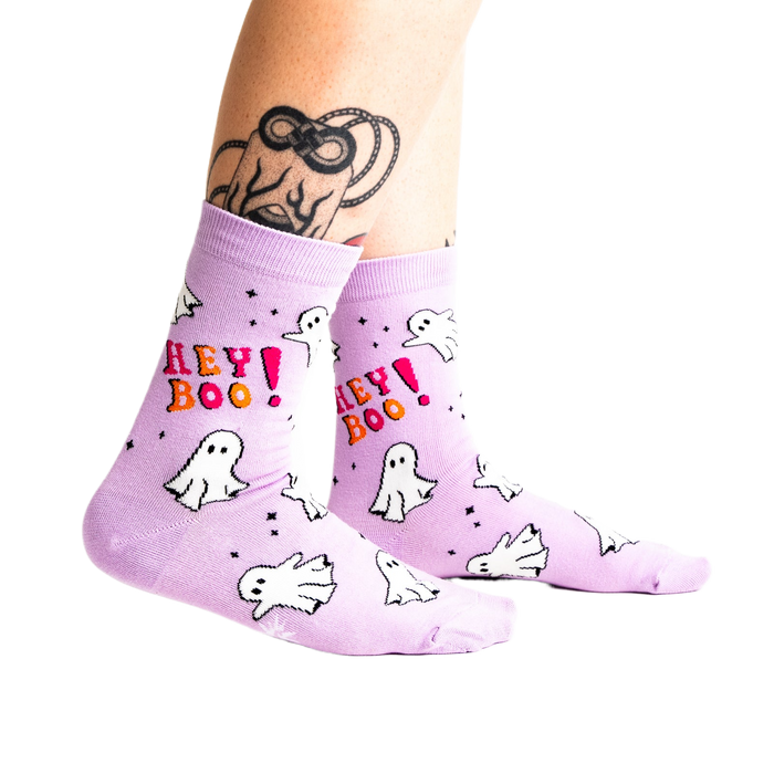 A person's tattooed legs wearing the light lavender 
