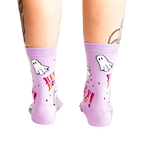 A back view of a person's legs wearing the light lavender ghost "Hey Boo!" crew socks, showing the heel and calf.