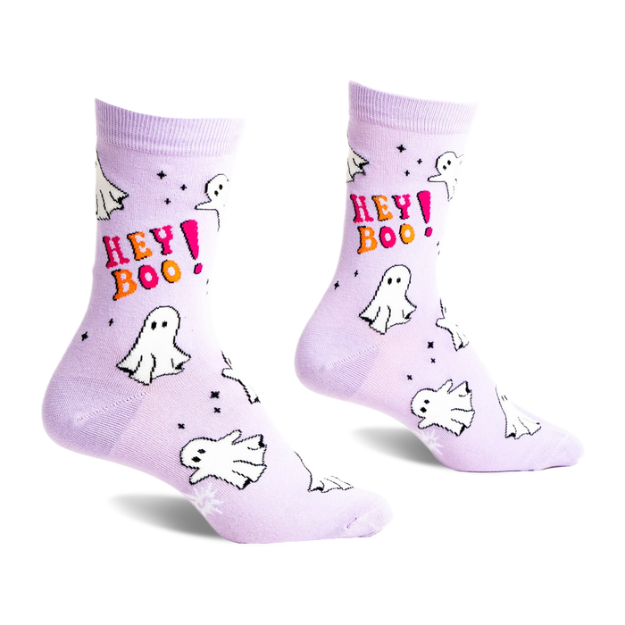 A pair of light lavender crew socks featuring white cartoon ghosts, pink and orange 