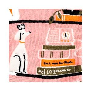 Close-up detail shot showcasing the charming illustrations of books, plants and dogs on the socks.