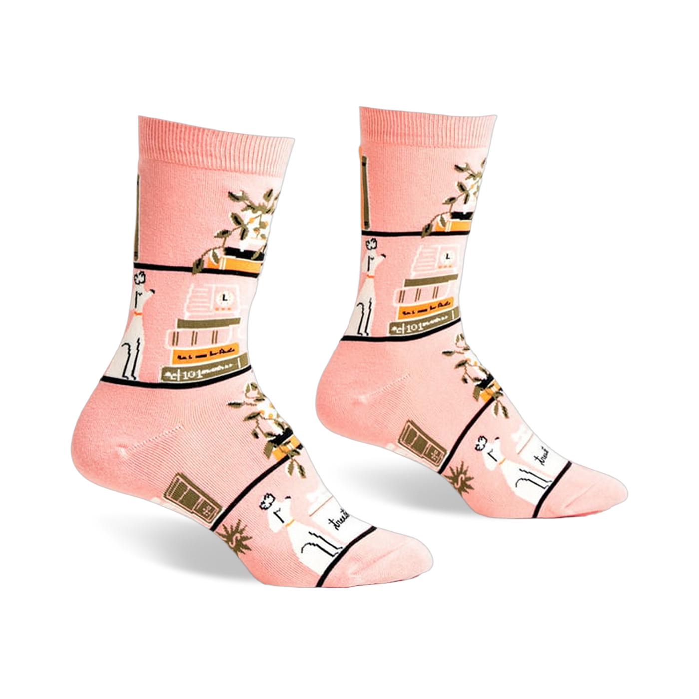 Pair of pink crew socks with a whimsical design of books, plants, and white dogs on a blush pink background.