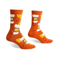 Pair of crew socks in burnt orange featuring a pattern of pumpkin spice latte cups, autumn leaves, and coffee beans.