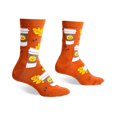 Pair of crew socks in burnt orange featuring a pattern of pumpkin spice latte cups, autumn leaves, and coffee beans.