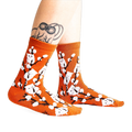 Lifestyle shot of the Kitten Willow socks on a model's legs, showing how they look when worn.
