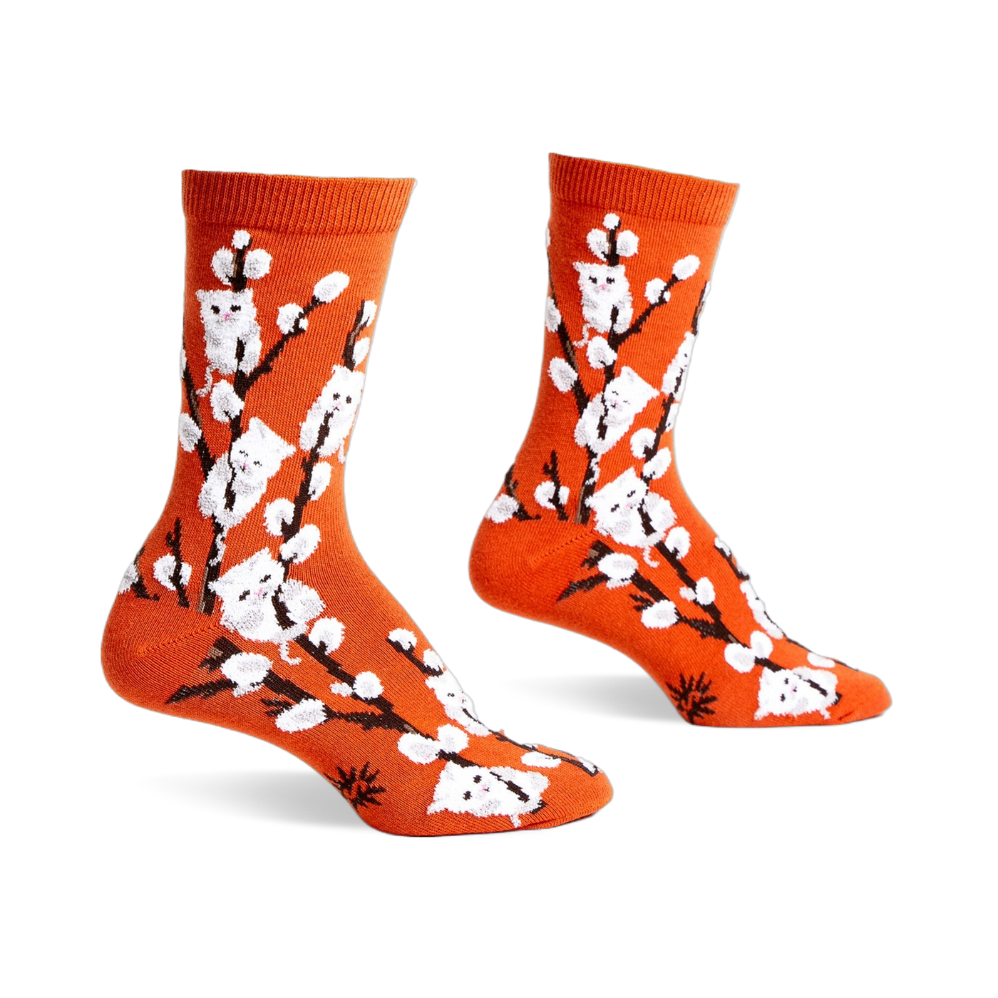 Pair of orange crew socks with a whimsical design featuring white kittens playfully perched on willow branches.