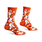 Pair of orange crew socks with a whimsical design featuring white kittens playfully perched on willow branches.