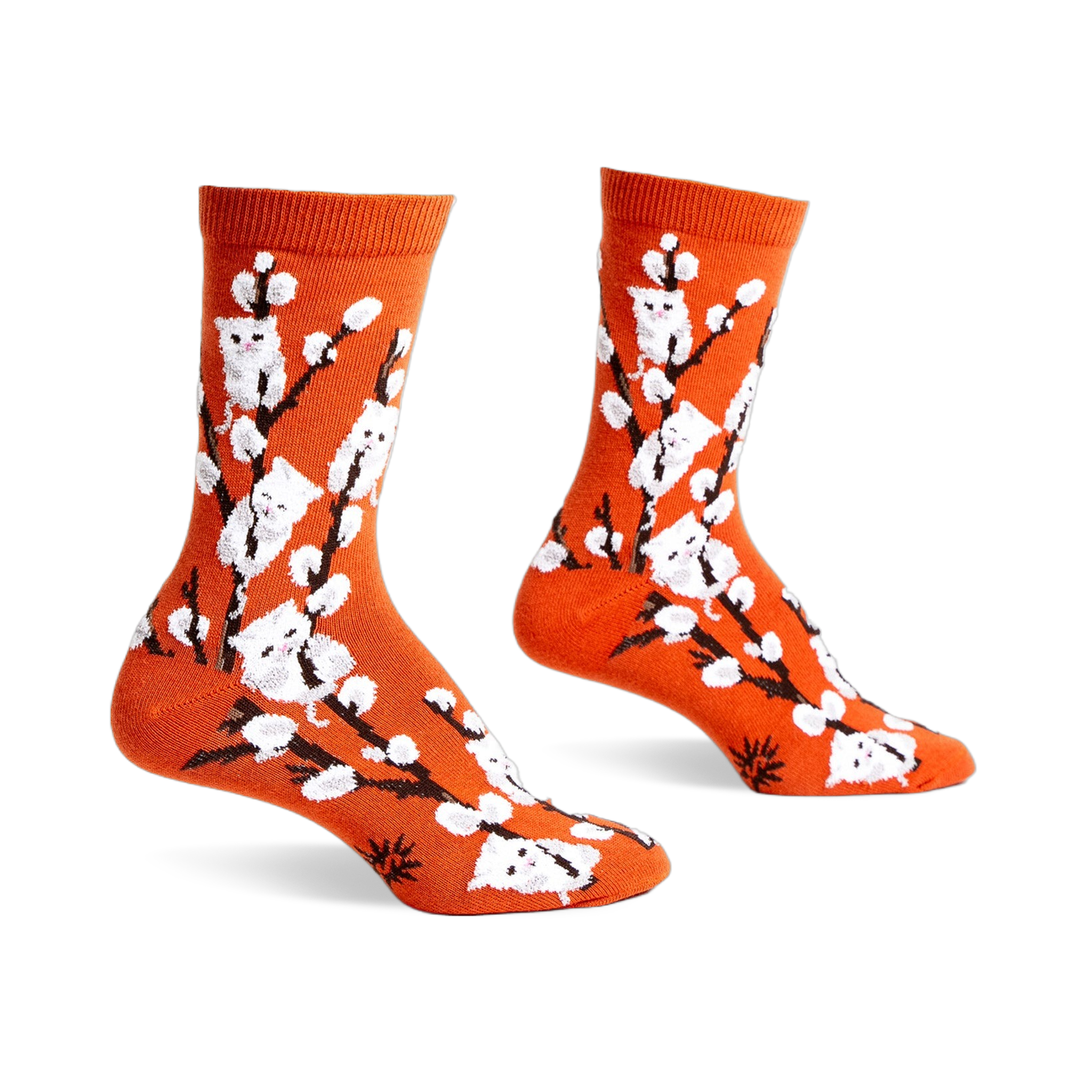 Pair of orange crew socks with a whimsical design featuring white kittens playfully perched on willow branches.