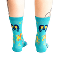 Back view of the teal zodiac socks, showcasing the design's full coverage.
