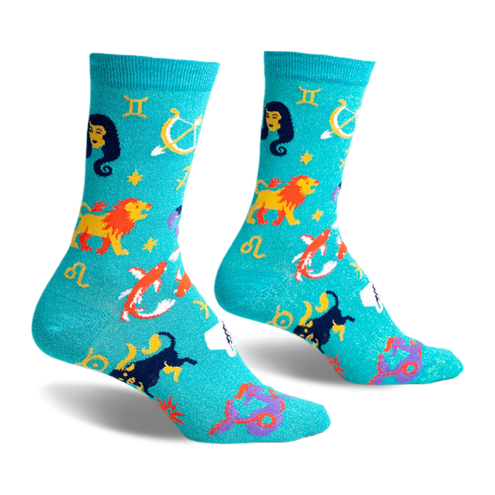 front view of a pair of teal blue socks with zodiac symbols. the socks have a glitter finish.  the socks feature a yellow lion, a purple scorpion, a pink fish, a white fish, a yellow archer and a blue and yellow gemini symbol on them.  the socks have a yellow 