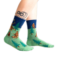 Lifestyle shot of Sasquatch Campout socks on a person's legs. 