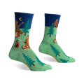 Crew socks in green and navy blue featuring a Bigfoot camping scene with trees, a campfire, and a Bigfoot playing a banjo under a starry night sky.