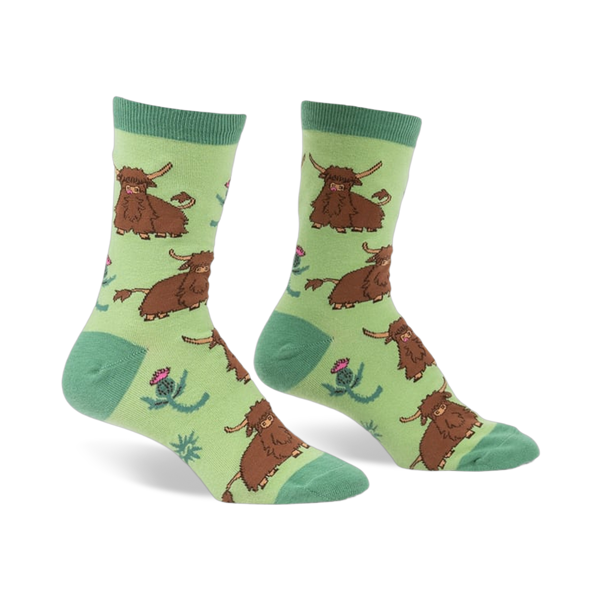 Pair of crew socks featuring a repeating pattern of brown Highland cows and pink thistles on a light green background.